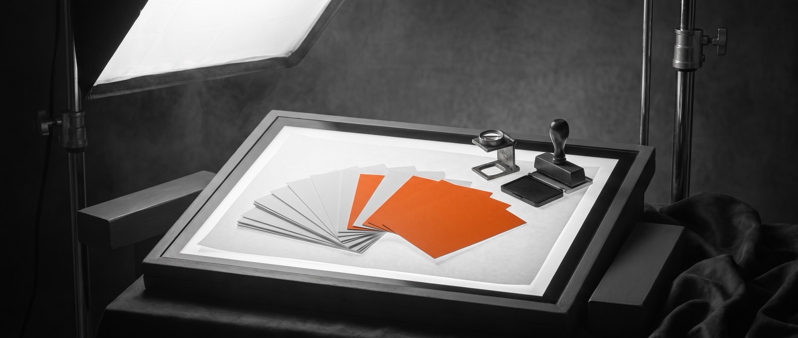 Postcard proofs fanned on a light table